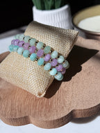 Three beaded stretch bracelets with rondelle beads separated by a gold spacer beads, displayed as a bracelet stack.