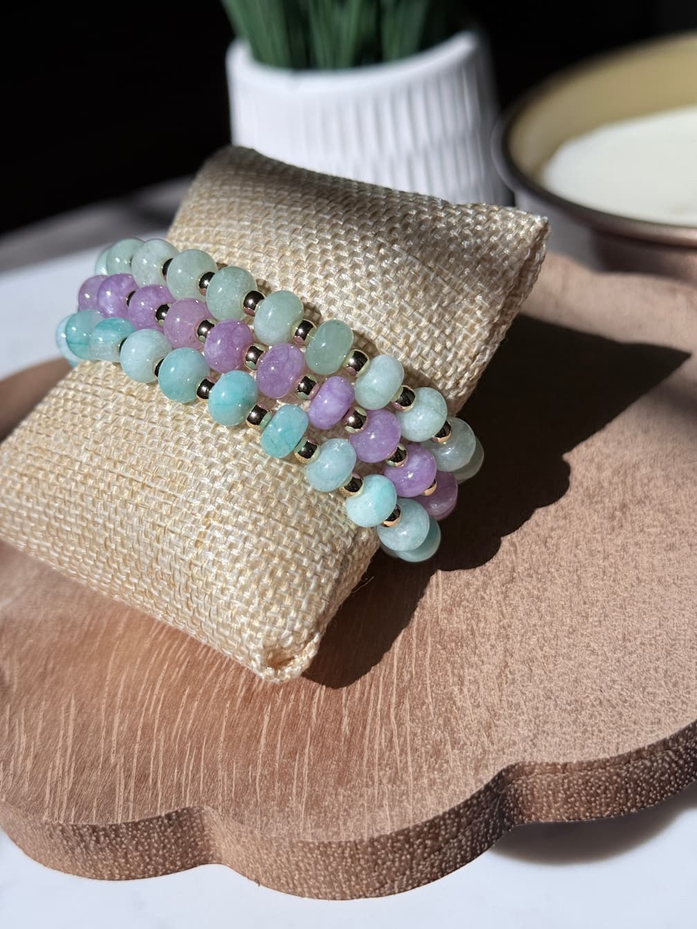Three beaded stretch bracelets with rondelle beads separated by a gold spacer beads, displayed as a bracelet stack.