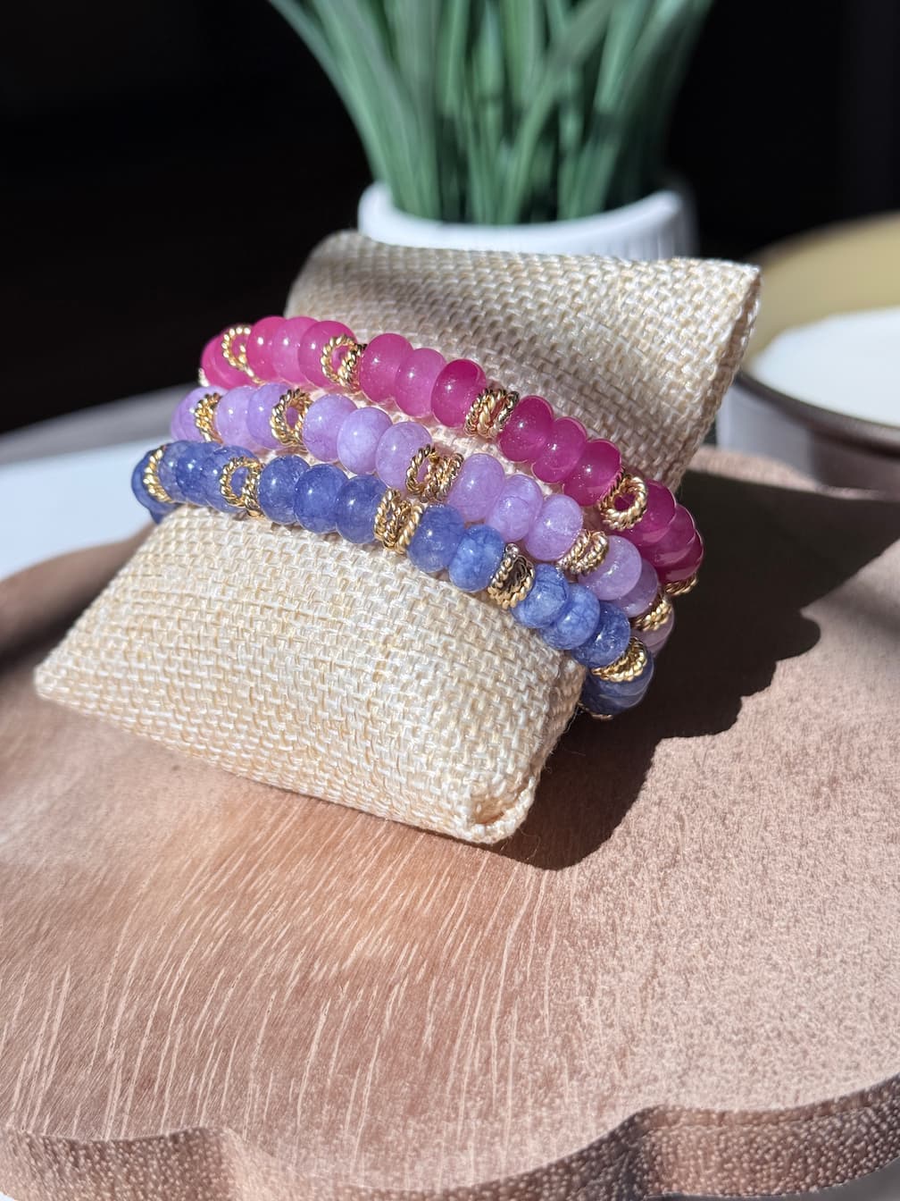 Three beaded stretch bracelets with rondelle beads separated by a gold twist spacer beads, displayed as a bracelet stack.